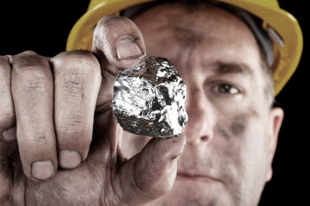 A silver miner shows off his newly excavated silver nugget.